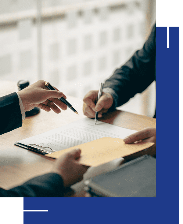 Business meeting with documents and pens on table.