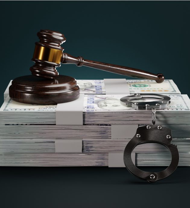 Gavel, money, and handcuffs on dark background.